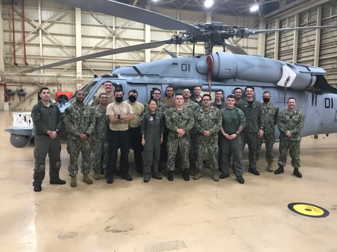 A team of U.S. Navy Sailors pose for a group photo after completing a rescue mission at Andersen Air Force Base, Guam, July 25, 2021. Members of the U.S. Air Force, U.S. Navy, U.S. Coast Guard worked together to save a U.S. Army Soldier who sustained injuries while on an Army Watercraft System during Exercise Forager 21.