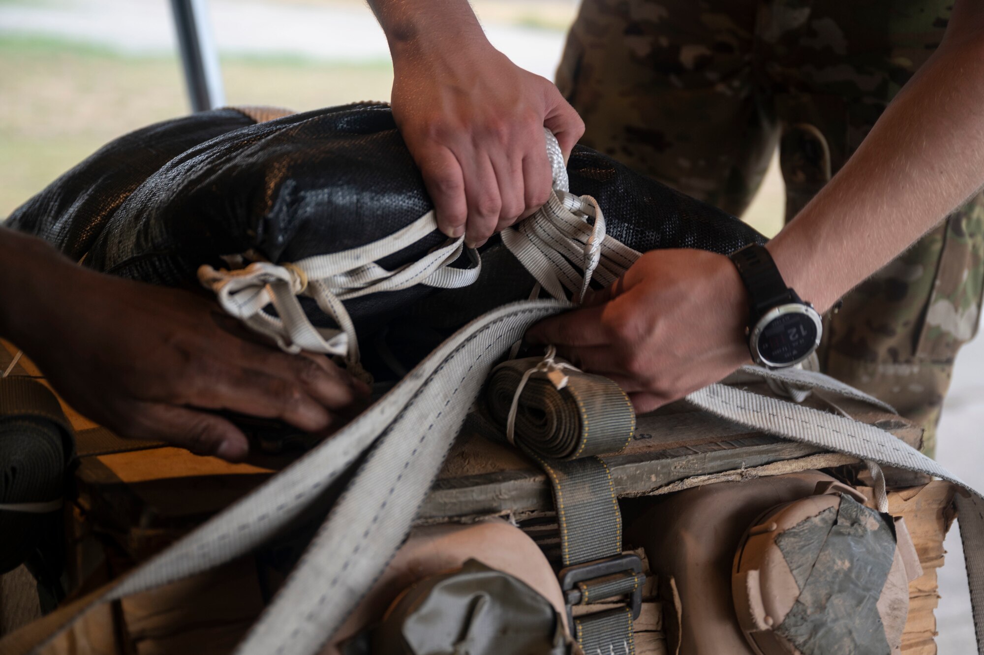 Two U.S. Air Force loadmasters assigned to the 37th Airlift Squadron secure cargo on a C-130J Super Hercules aircraft during exercise Agile Spirit 21