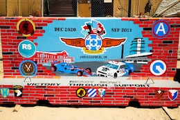 The completed T-wall for the 310th Sustainment Command (Expeditionary) at Camp Arifjan, Kuwait.  Chief Warrant Officer 2 Paul Viall worked countless hours in extreme heat to paint a mural that will represent the hard work and dedication of the Army Reserve’s Indianapolis-based “Brickyard” Soldiers and their time serving within the U.S. Central Command’s area of responsibility.