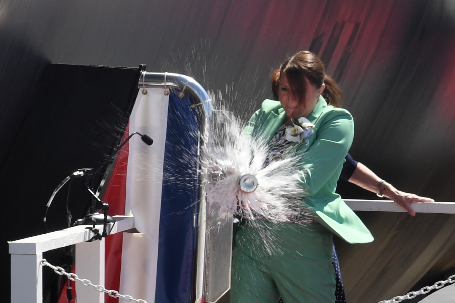 Sarah Greenert McNichol, Matron of Honor for the future USS Hyman G. Rickover (SSN 795), christens the ship during a ceremony at General Dynamics Electric Boat shipyard facility in Groton, Conn., July 31, 2021.