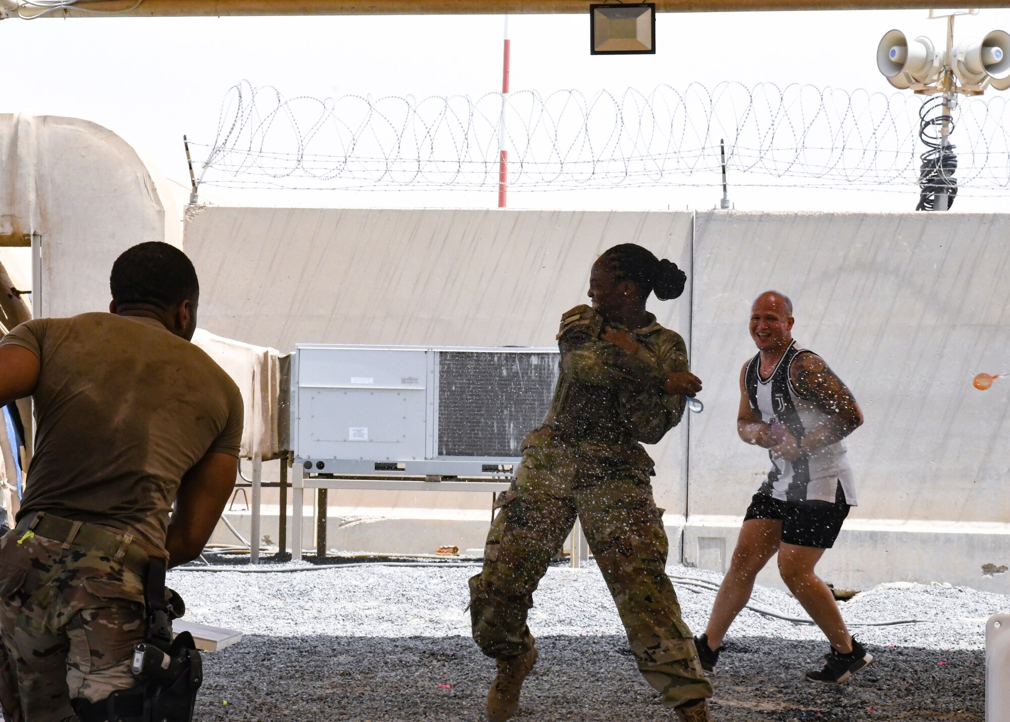 A photo of an Airman in a water balloon fight