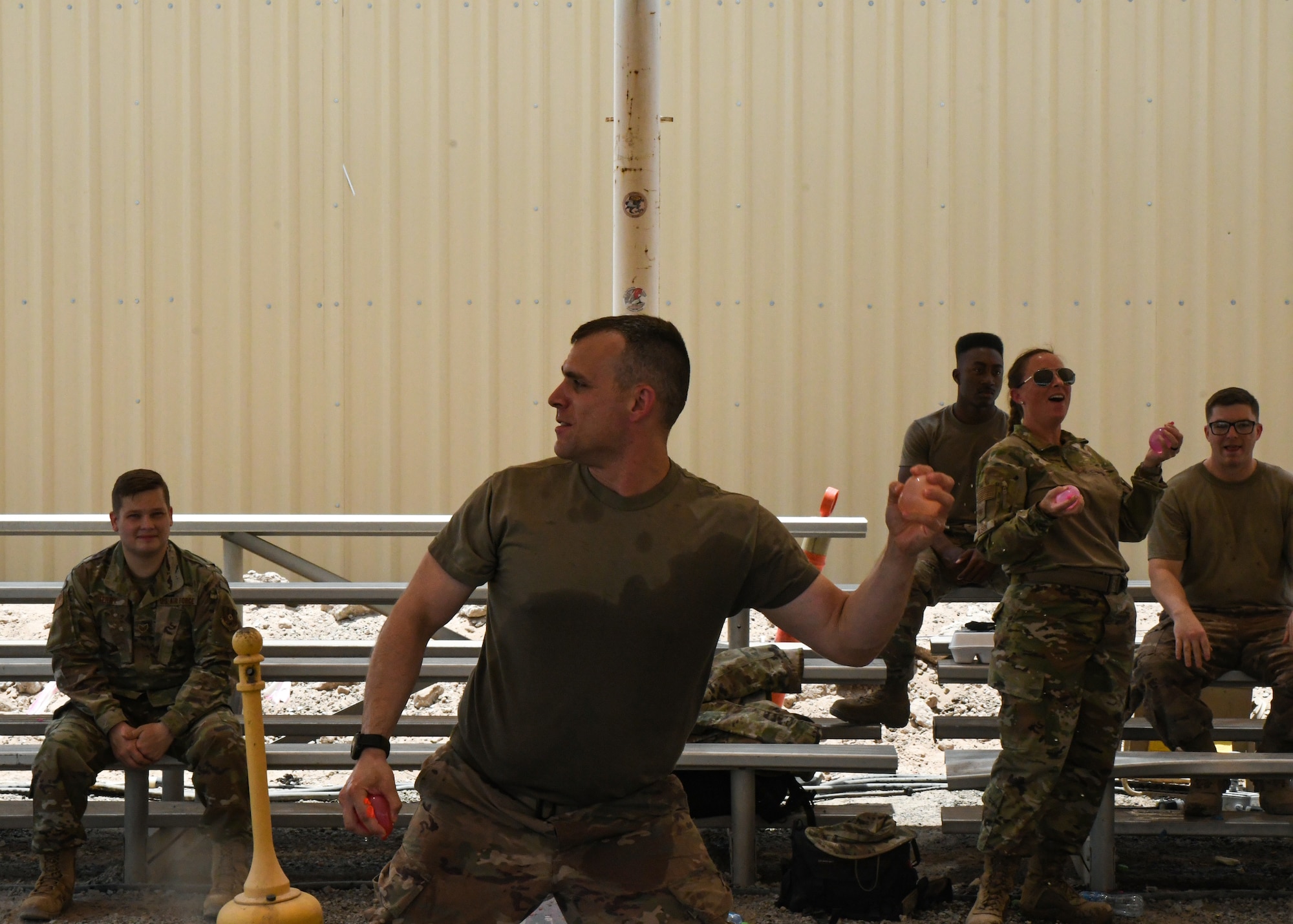 A photo of an Airman throwing a water balloon