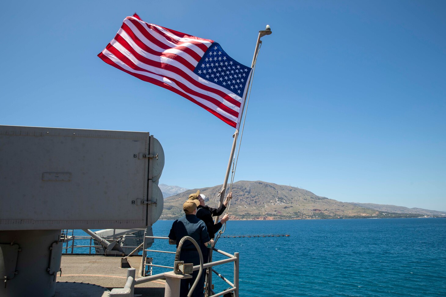 Sailors shift colors as the Wasp-class amphibious assault ship USS Iwo Jima (LHD 7) moored in Souda Bay, Greece, May 27, 2021. Iwo Jima is underway in the Mediterranean Sea with Amphibious Squadron 4 and 24th MEU as part of the Iwo Jima Amphibious Ready Group.