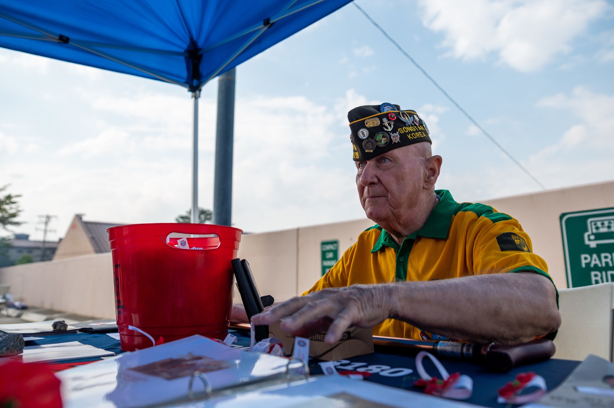 Ermest Lee, a former post commander of the Veterans of Foreign Wars, 8180 Korea, displays photos from past military events during a Memorial Day remembrance event at Osan Air Base, Republic of Korea, May 28, 2021. Memorial Day was made an official federal holiday in 1971. (U.S. Air Force photo by Senior Airman Branden Rae)