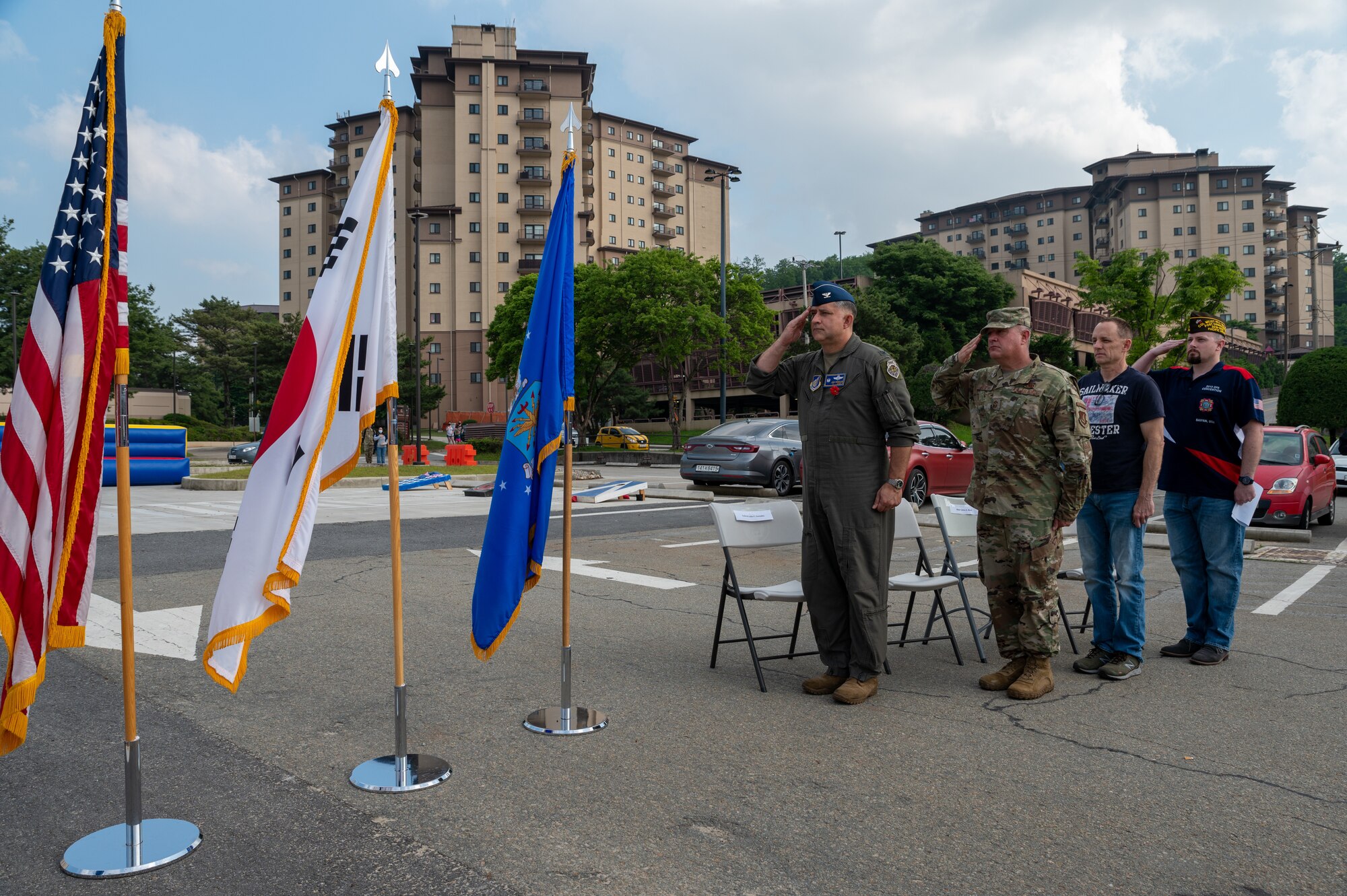 Distinguished guests salute the flags while each national anthem plays during a Memorial Day remembrance event at Osan Air Base, Republic of Korea, May 28, 2021. Memorial Day is for honoring the men and women who have died while on duty with the U.S. military. (U.S. Air Force photo by Senior Airman Branden Rae)