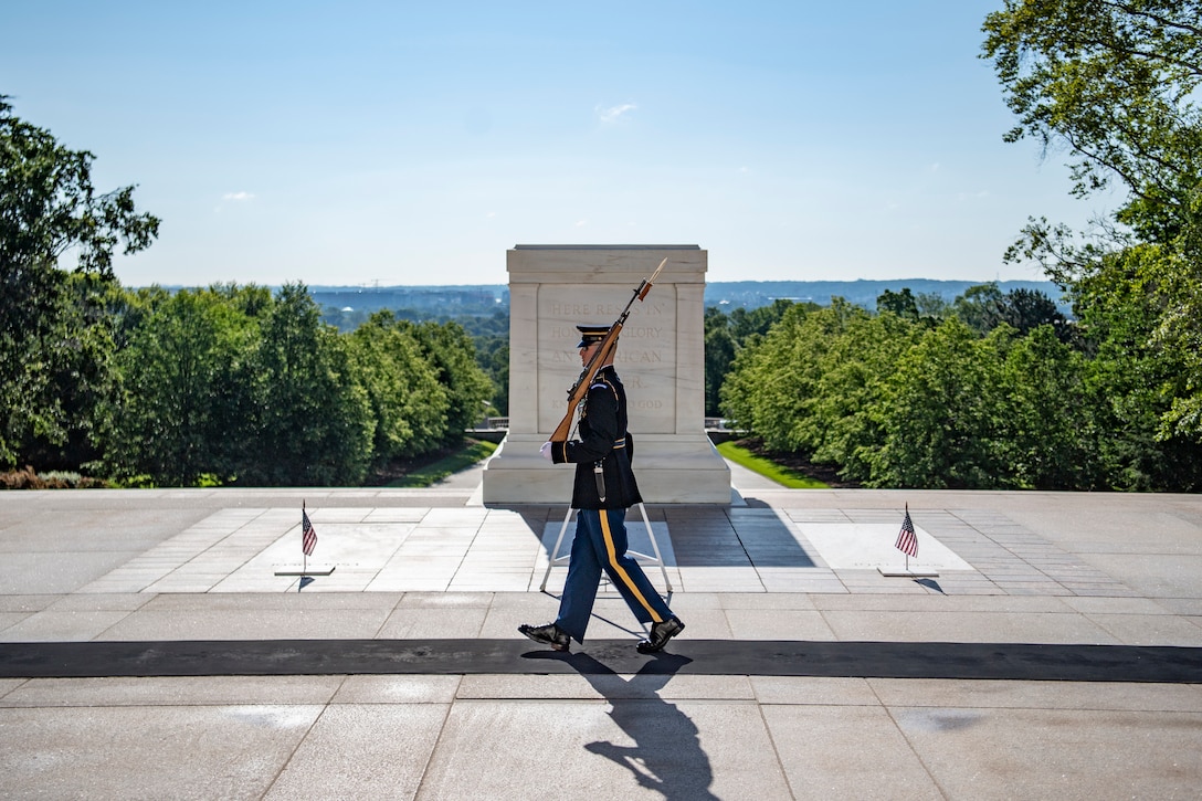 A soldier walks in front of the Tomb of the Unknown Soldier.