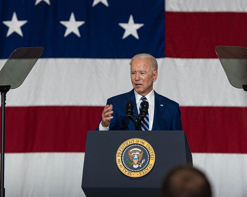 President Joe Biden and first lady Jill Biden interact with service members.