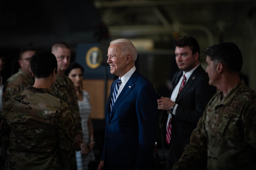 President Joe Biden interacts with service members.