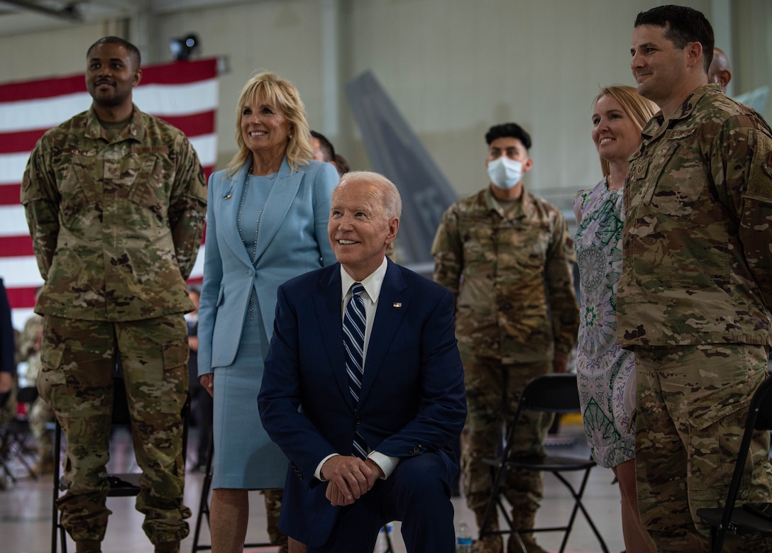 President Joe Biden and first lady Jill Biden interact with service members.