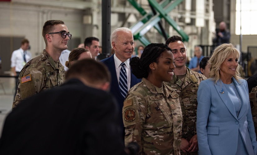 President Joe Biden and first lady Jill Biden interact with service members.