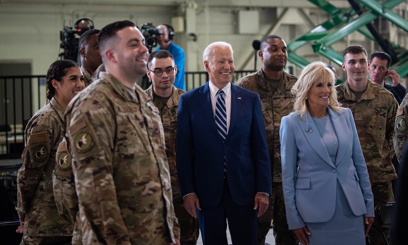 President Joe Biden and first lady Jill Biden interact with service members.