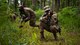 Master Sgt. Perry Link, 2nd Civil Engineer Squadron engineering flight superintendent, provides cover for Airman 1st Class Kelly Hollis III, 2nd CES heating, ventilation, and air conditioning journeyman, during an individual movement techniques and unidentified explosive ordnance portion of a training exercise at Barksdale Air Force Base, Louisiana, May 20, 2021. Training operational skills such as land navigation, weapons assembly and individual movement techniques, the 2nd CES intensified the readiness of it’s engineers, allowing the unit to better adapt to changes in the national security environment and compete in the dynamic future of warfighting. (U.S. Air Force photo by Senior Airman Jacob B. Wrightsman)