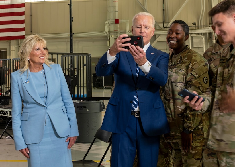 President Joe Biden poses for a selfie with joint service members.