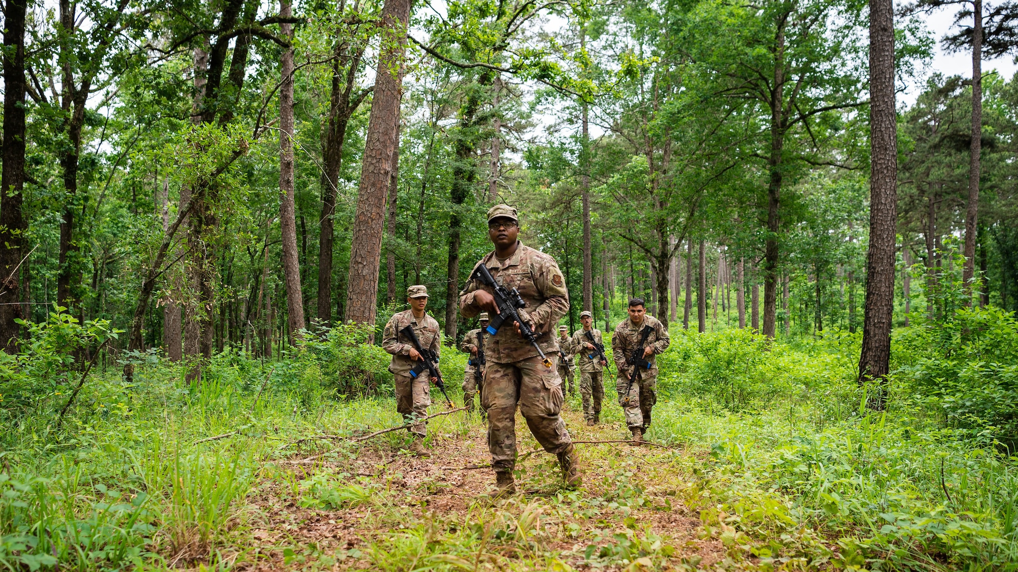 Airmen from the 2nd Civil Engineer Squadron perform individual movement techniques and unidentified explosive ordnance identification during a 2nd CES training exercise at Barksdale Air Force Base, Louisiana, May 20, 2021. Training operational skills such as land navigation, weapons assembly and individual movement techniques, the 2nd CES intensified the readiness of its engineers, allowing the unit to better adapt to changes in the national security environment and compete in the dynamic future of warfighting. (U.S. Air Force photo by Senior Airman Jacob B. Wrightsman)