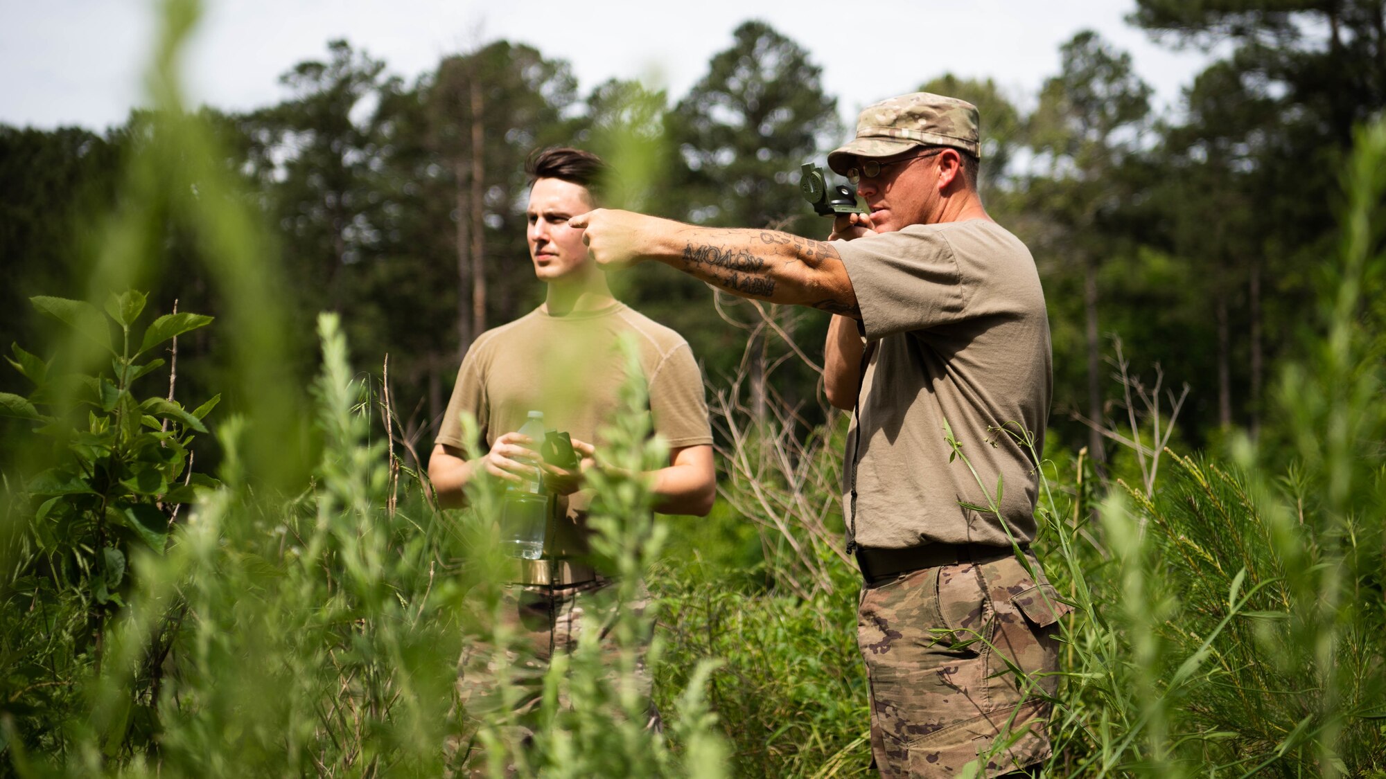 Airmen from the 2nd Civil Engineer Squadron perform land navigation during a 2nd CES training exercise at Barksdale Air Force Base, Louisiana, May 20, 2021. Training operational skills such as land navigation, weapons assembly and individual movement techniques, the 2nd CES intensified the readiness of it’s engineers, allowing the unit to better adapt to changes in the national security environment and compete in the dynamic future of warfighting. (U.S. Air Force photo by Senior Airman Jacob B. Wrightsman)