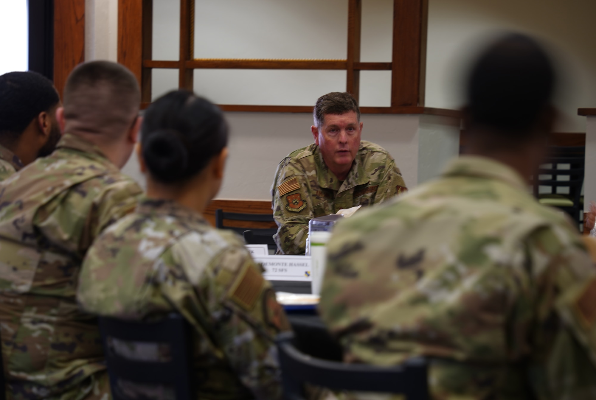 A general looking toward a group of young airmen.