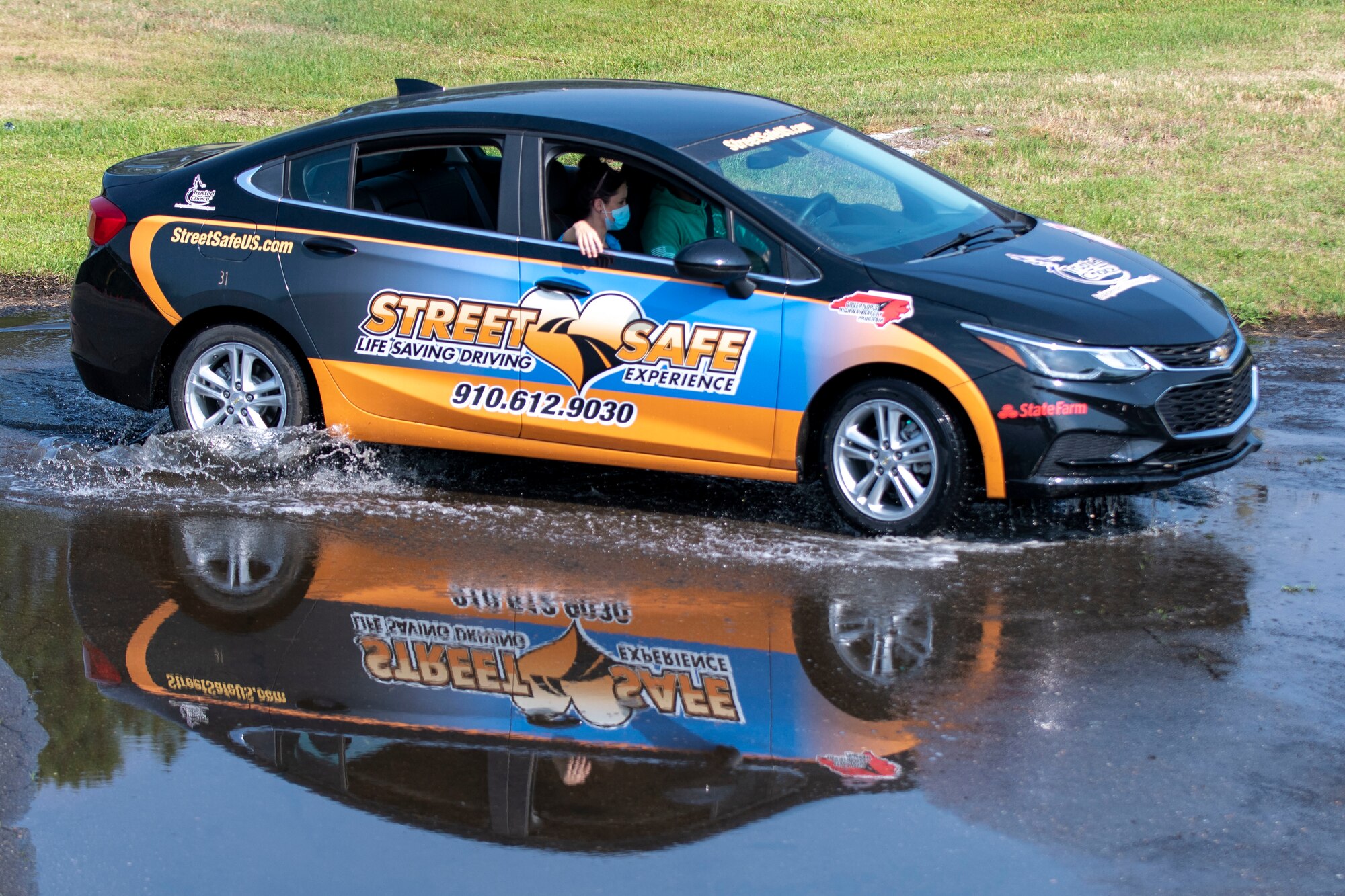 An Airman from Team Seymour drives through water during safe driving training at Seymour Johnson Air Force Base, North Carolina, May 26, 2021.