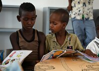 Children from Ali Adde village read together at the new Ali Adde school library in in Ali Adde, Djibouti, May 27, 2021. The new library was a U.S.-funded construction project which created local jobs and was built by a Djiboutian construction company employing Djiboutian laborers.