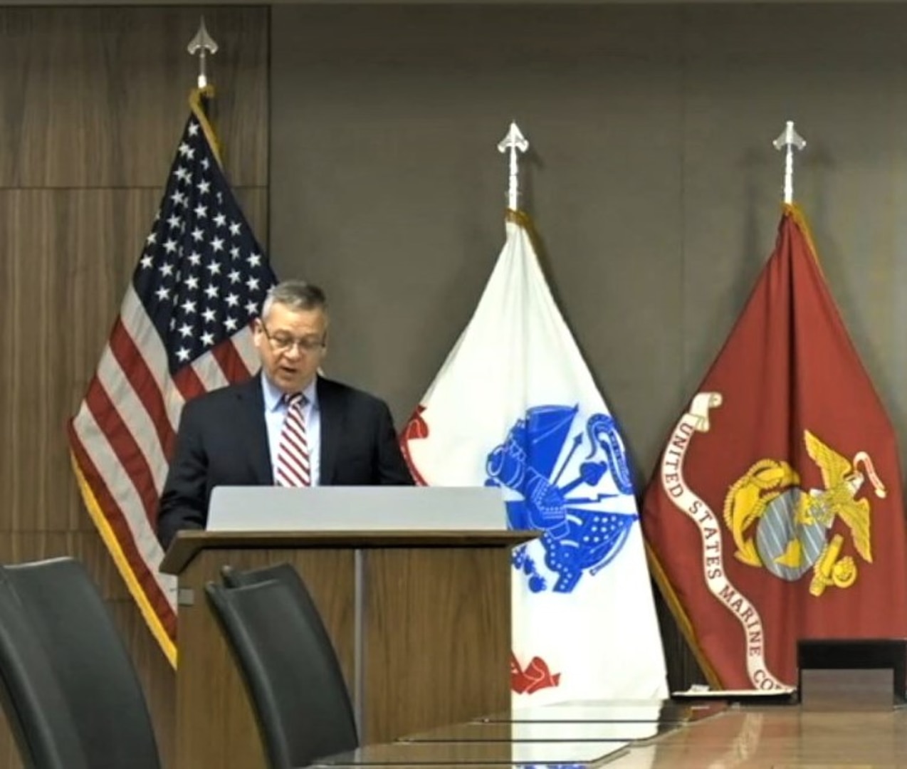 Man speaks at podium