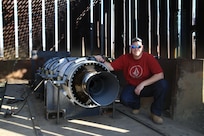IMAGE: Naval Surface Warfare Center Dahlgren Division (NSWCDD) test engineer Lanie Pepitone poses with a Standard Missile rocket motor.