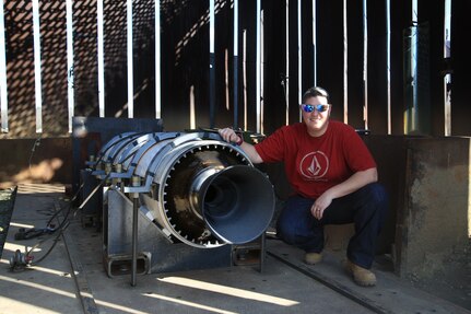 IMAGE: Naval Surface Warfare Center Dahlgren Division (NSWCDD) test engineer Lanie Pepitone poses with a Standard Missile rocket motor.