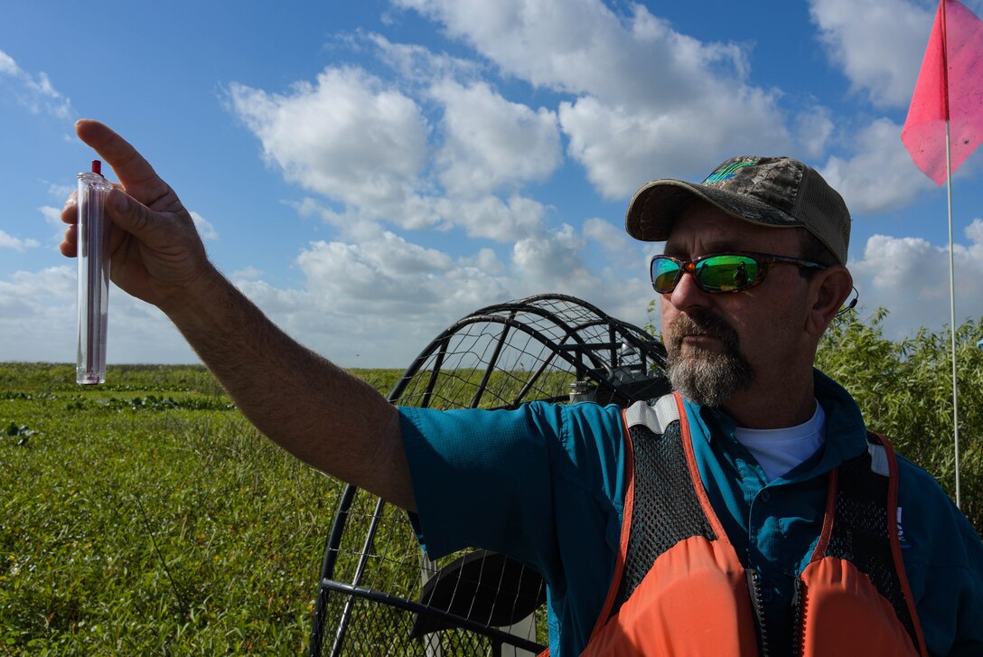 Applied Aquatics, project manager, Keith Mangus demonstrates how to use  a wind meter. The wind plays an important role when managing invasive aquatic plants with chemical sprays. The Portable Series Wind Meter is used to indicate wind speed and direction. Licensed applicators use this device along with guidance from the Environmental Protection Agency to determine whether or not to spray invasive aquatic plants.