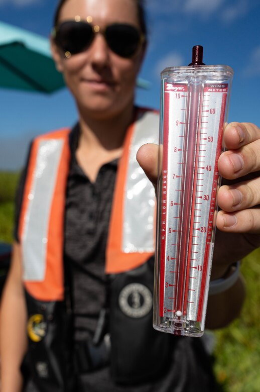 U.S. Army Corps of Engineers, biologist, Jessica Fair holds up a Portable Series Wind Meter is used to indicate wind speed. Licensed applicators use this device along with guidance from the Environmental Protection Agency to determine whether or not to spray invasive aquatic plants.
