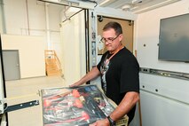 Photo of Alan Baker installing furniture and equipment into the ARSS V2.