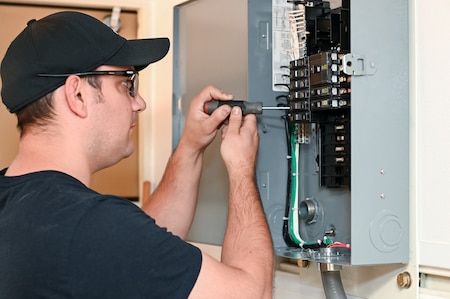 Photo of Trevor Lutz performs electrical work on the ARSS V2.