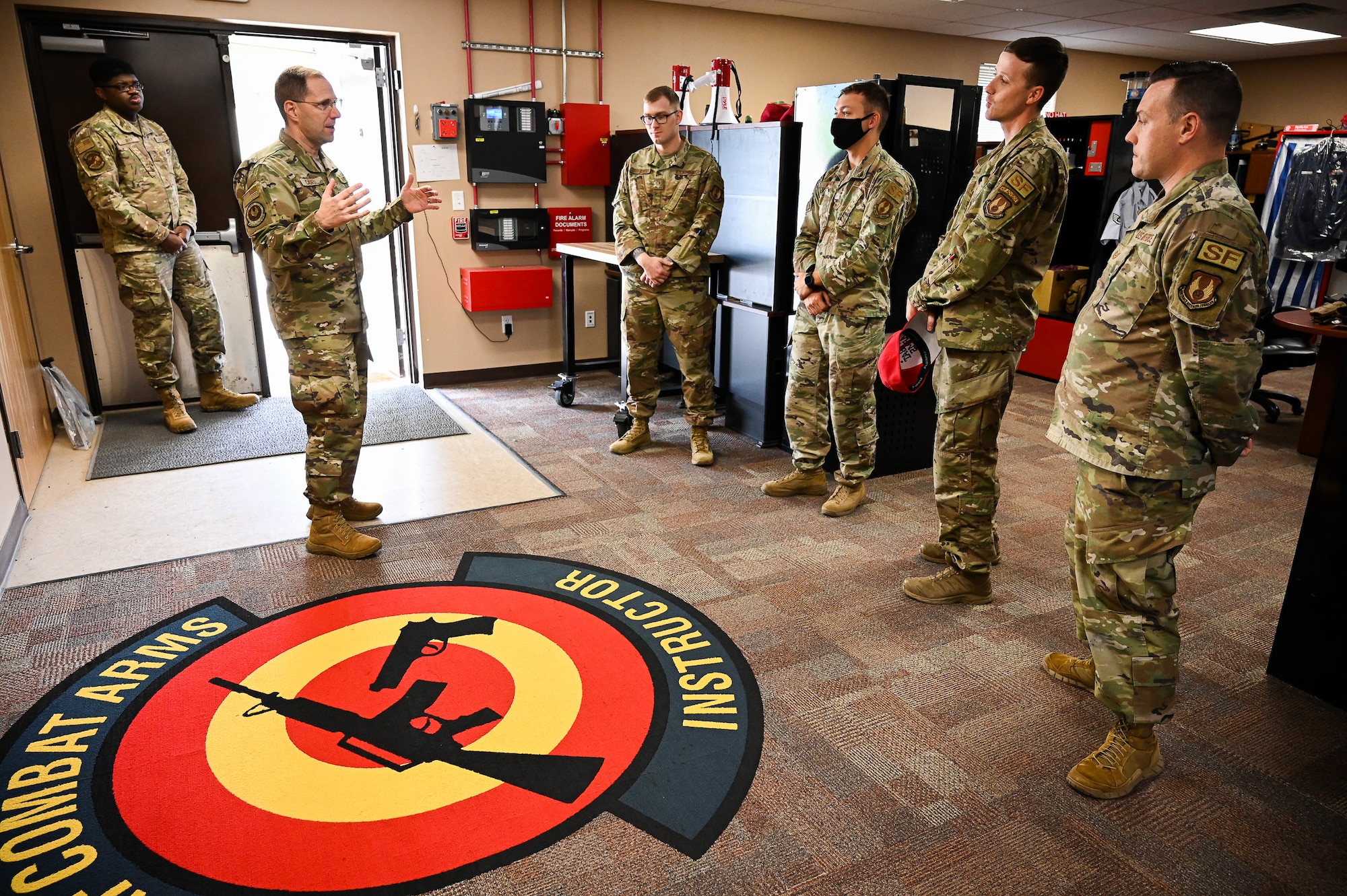 Chief Master Sgt. Stanley C. Cadell, command chief of Air Force Materiel Command, speaks with 75th Security Forces Squadron combat arms instructors at Hill Air Force Base, Utah, May 25, 2021. (U.S. Air Force photo by R. Nial Bradshaw)