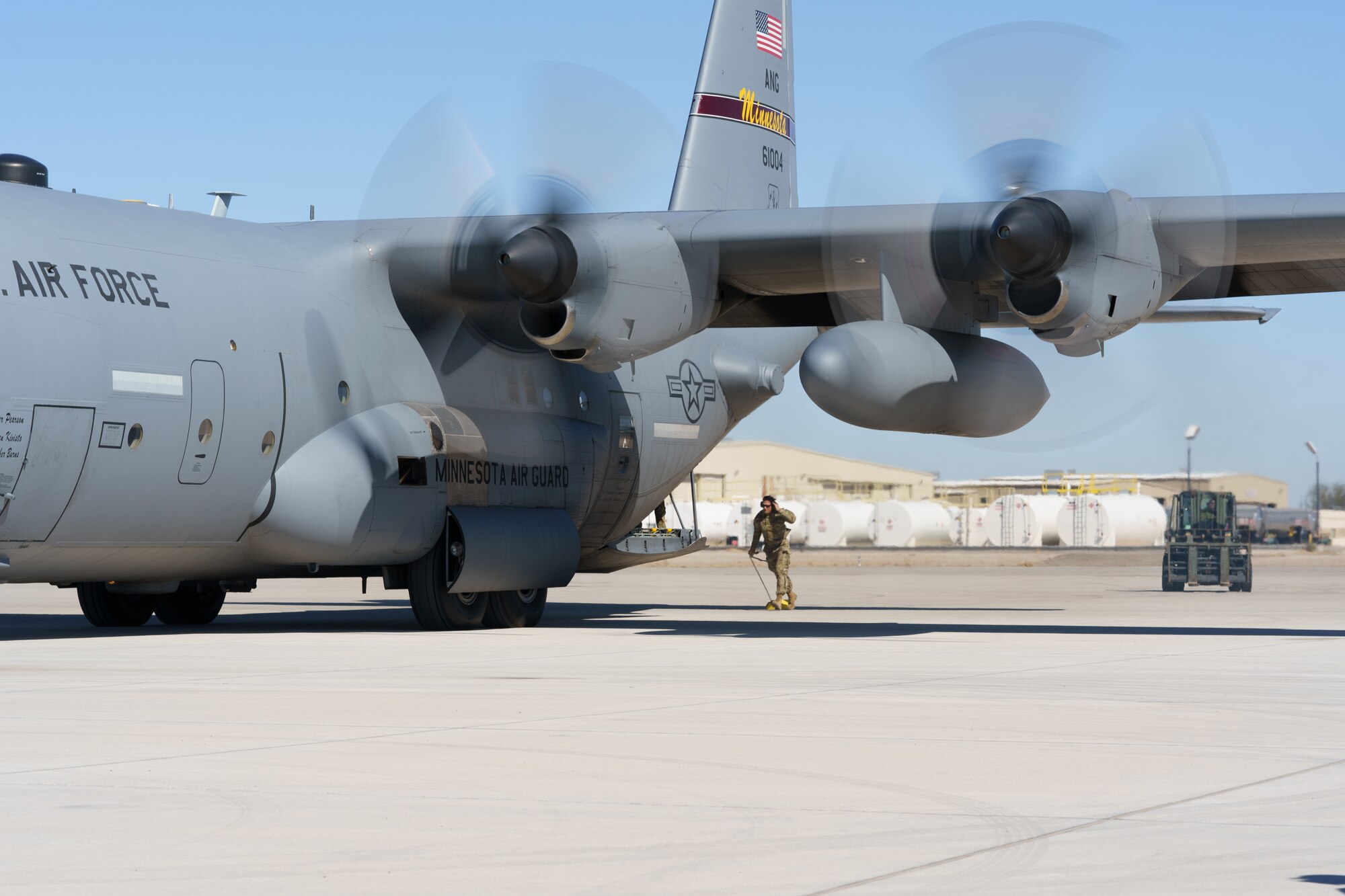 U.S. Air Force Master Sgt. Casey Jaeger, left, and Master Sgt. Brian Prestegaard, 133rd Air Transportation Function, prepare to conduct an engine running offload from a C-130 Hercules in  Yuma, Ariz., Feb. 25, 2021.