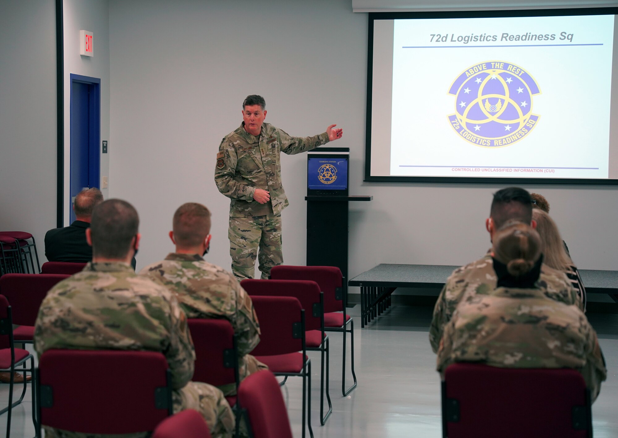 A general standing in front of a group of Airmen