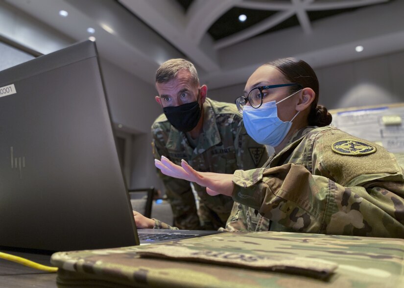 U.S. Army Reserve Spc. Kimberly Soto (right), a human resources specialist with the 338th Medical Brigade, 3rd Medical Command Deployment Support, goes over her personal readiness processes with Commanding General Maj. Gen. Joe Robinson, 3rd Medical Command Deployment Support, during U.S. Army North’s exercise Vibrant Response 21.
