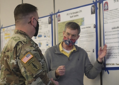 Kevin Kirmse (right), an exercise planner for U.S. Army North, explains to Brig. Gen. Paul Chauncey, U.S. Army North’s Deputy Commanding General, the training objectives for Task Force 76 during Vibrant Response 21.