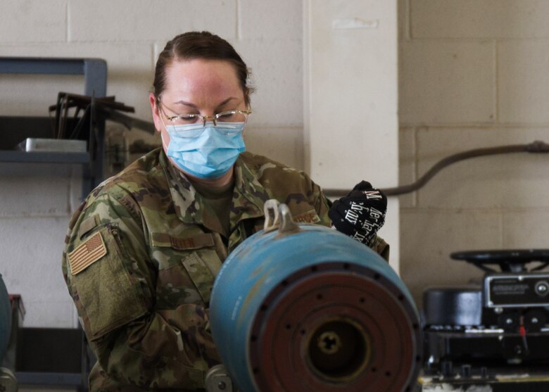 Photo of Airman building a munition.