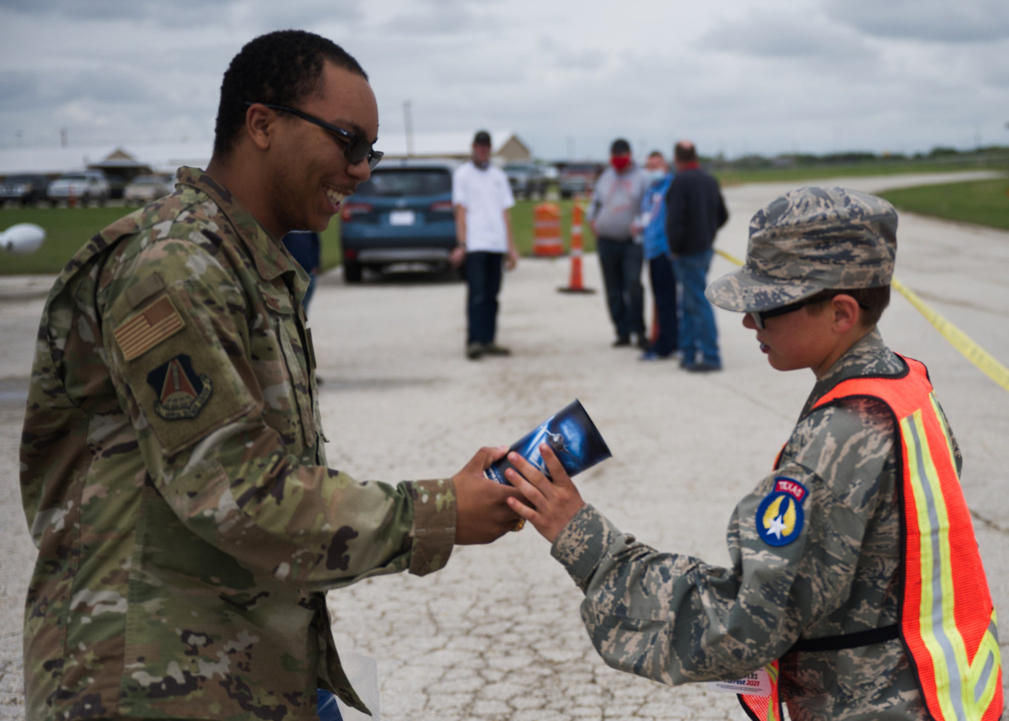 Photo of Airman handing out recruiting items.