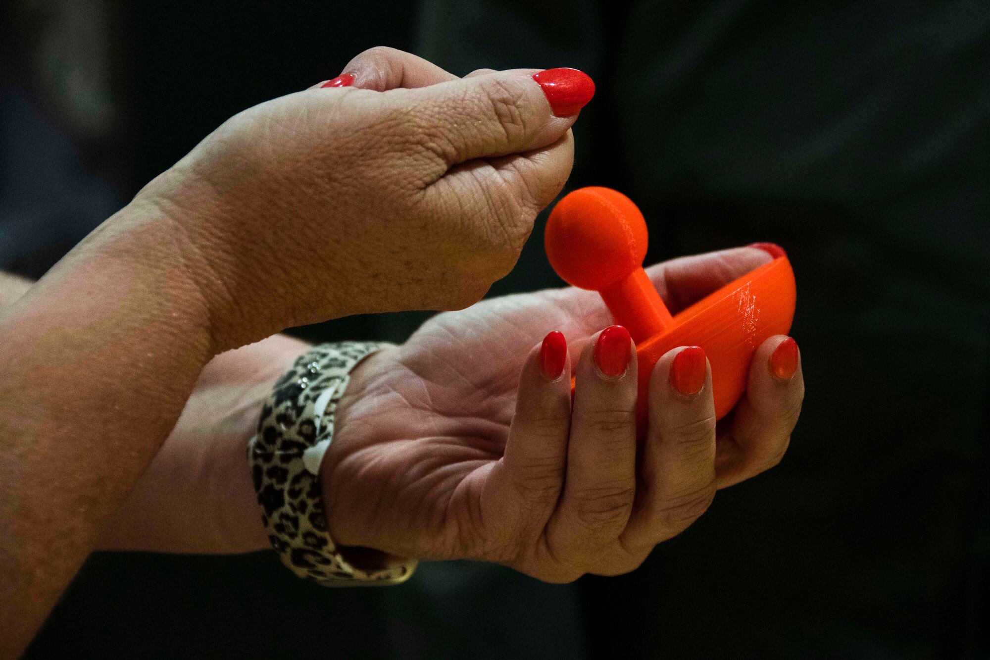 Photo of two hands holding a B-52 part