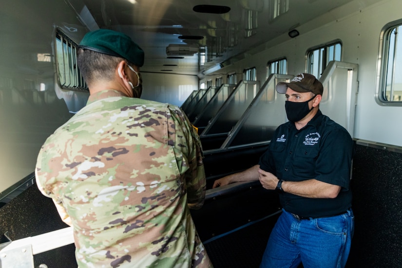 U.S. Army Sgt. 1st Class Timothy French, right, assigned to the U.S. Army North Caisson Platoon, describes the advantages of the stalls located in the caisson platoon’s new trailer to Lt. Col. Richard Teta, left, U.S. Army North battalion commander on Joint Base San Antonio - Fort Sam Houston, April 8, 2021.