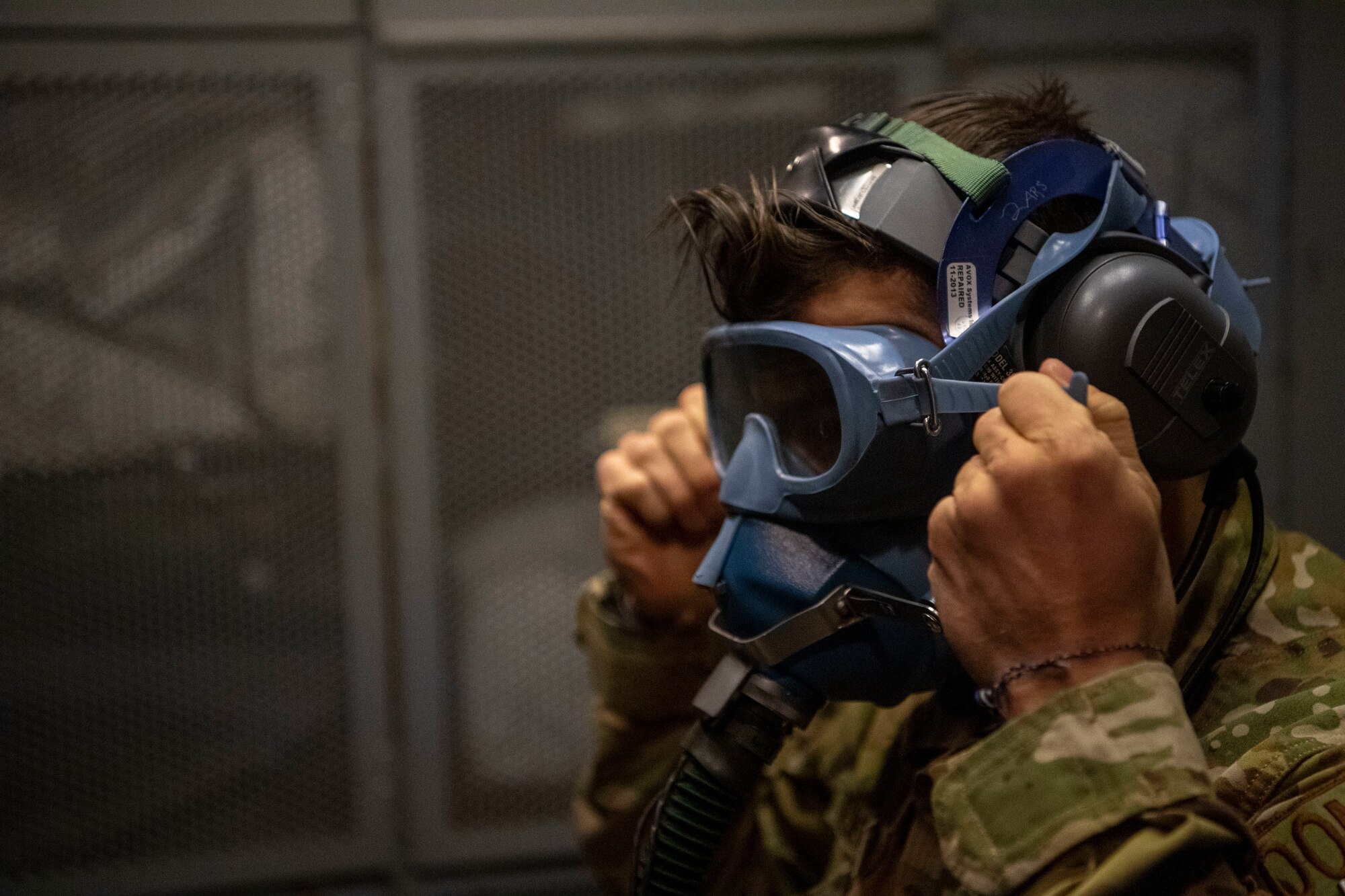 Photo of an Airman checking an oxygen mask prior to take off.