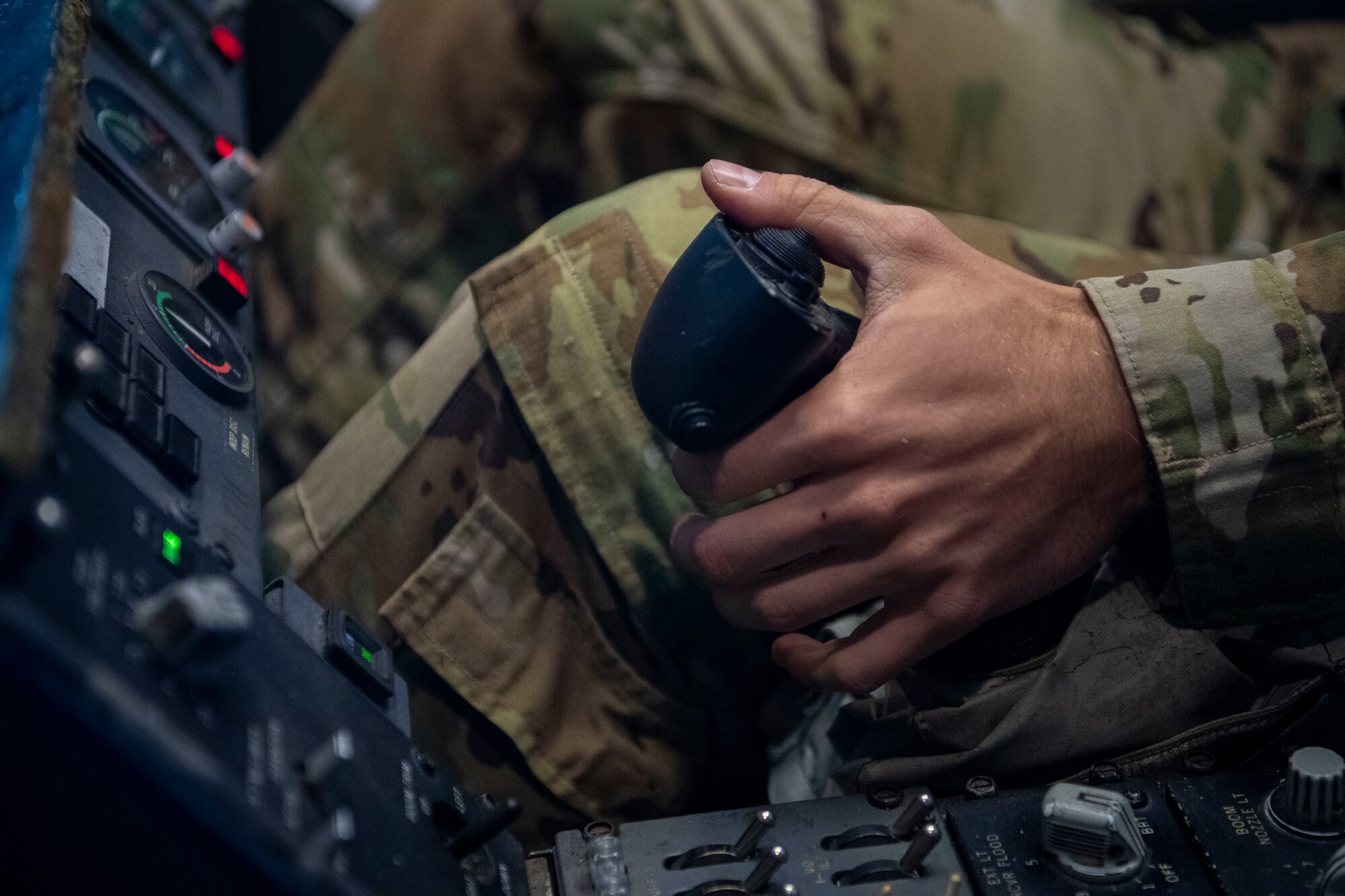 Photo of an Airman checking over controls.