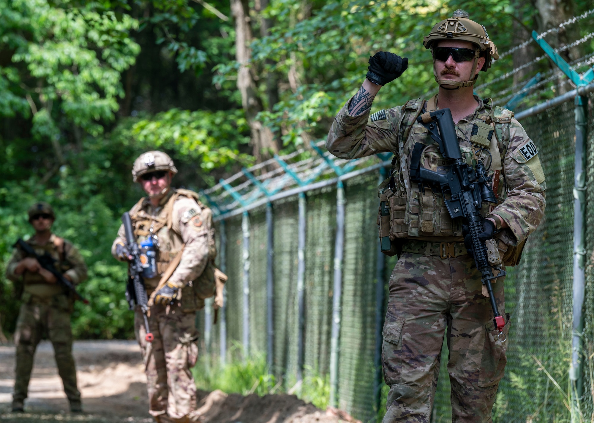 Airmen from the 436th Civil Engineer Squadron explosive ordnance disposal flight scout for improvised explosive devices during an exercise at Dover Air Force Base, Delaware, May 26, 2021. The exercise tested EOD personnel on the detection and diffusion of simulated IEDs. (U.S. Air Force photo by Airman 1st Class Cydney Lee)