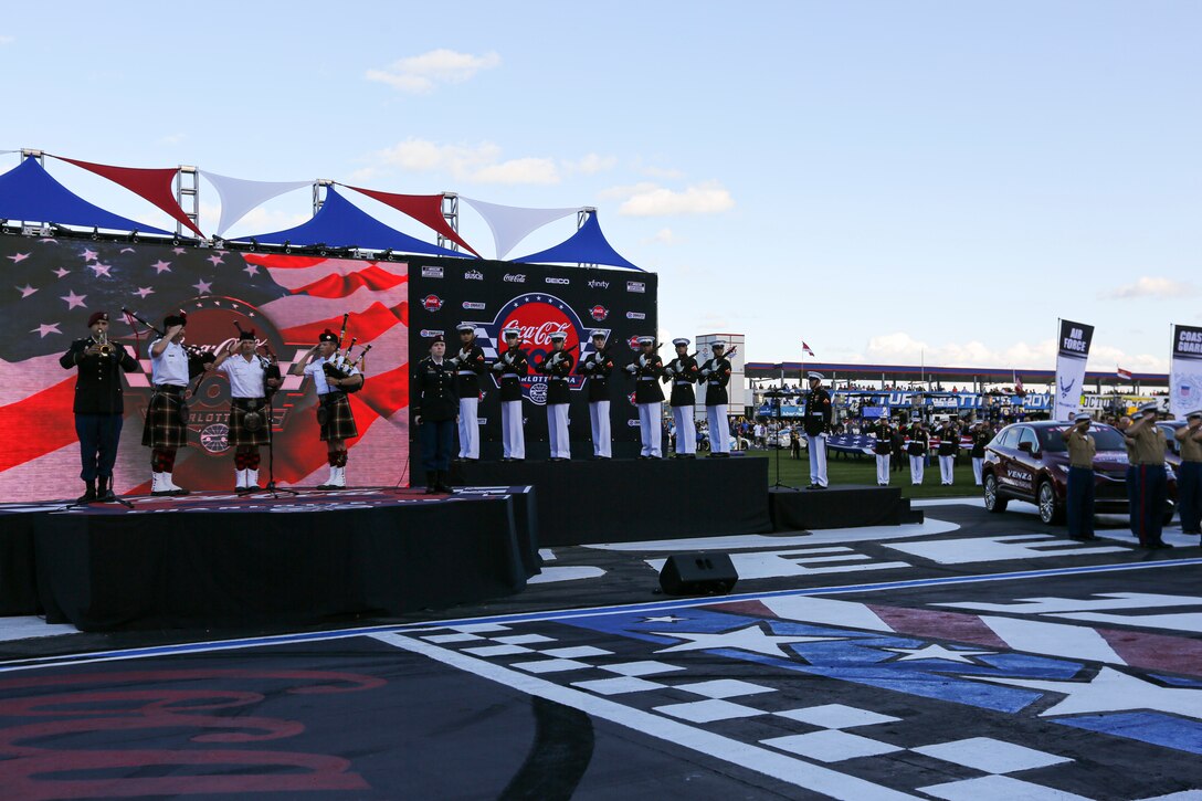A firing party from Alpha Company, Marine Barracks Washington, fires a three round volley prior to the Coca-Cola 600 at Charlotte Motor Speedway, Charlotte, North Carolina, May 30, 2021. The Official U.S. Marine Corps Color Guard and an Alpha Company firing party participated in the pre-race ceremony at Charlotte Motor Speedway in honor of Memorial Day. (U.S. Marine Corps photo by Lance Cpl. Tanner D. Lambert)