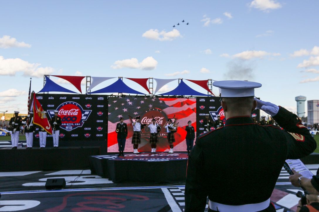 Staff Sgt. Franklin D. Taft, the 39th Color Sergeant of the Marine Corps, salutes during the national anthem prior to the Coca-Cola 600 at Charlotte Motor Speedway, Charlotte, North Carolina, May 30, 2021. The Official U.S. Marine Corps Color Guard and an Alpha Company firing party participated in the pre-race ceremony at Charlotte Motor Speedway in honor of Memorial Day. (U.S. Marine Corps photo by Lance Cpl. Tanner D. Lambert)