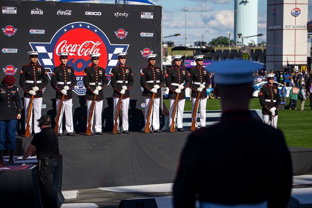 A firing party from Alpha Company, Marine Barracks Washington, stands at-ease prior to the Coca-Cola 600 at Charlotte Motor Speedway, Charlotte, North Carolina, May 30, 2021. The Official U.S. Marine Corps Color Guard and an Alpha Company firing party participated in the pre-race ceremony at Charlotte Motor Speedway in honor of Memorial Day. (U.S. Marine Corps photo by Lance Cpl. Tanner D. Lambert)