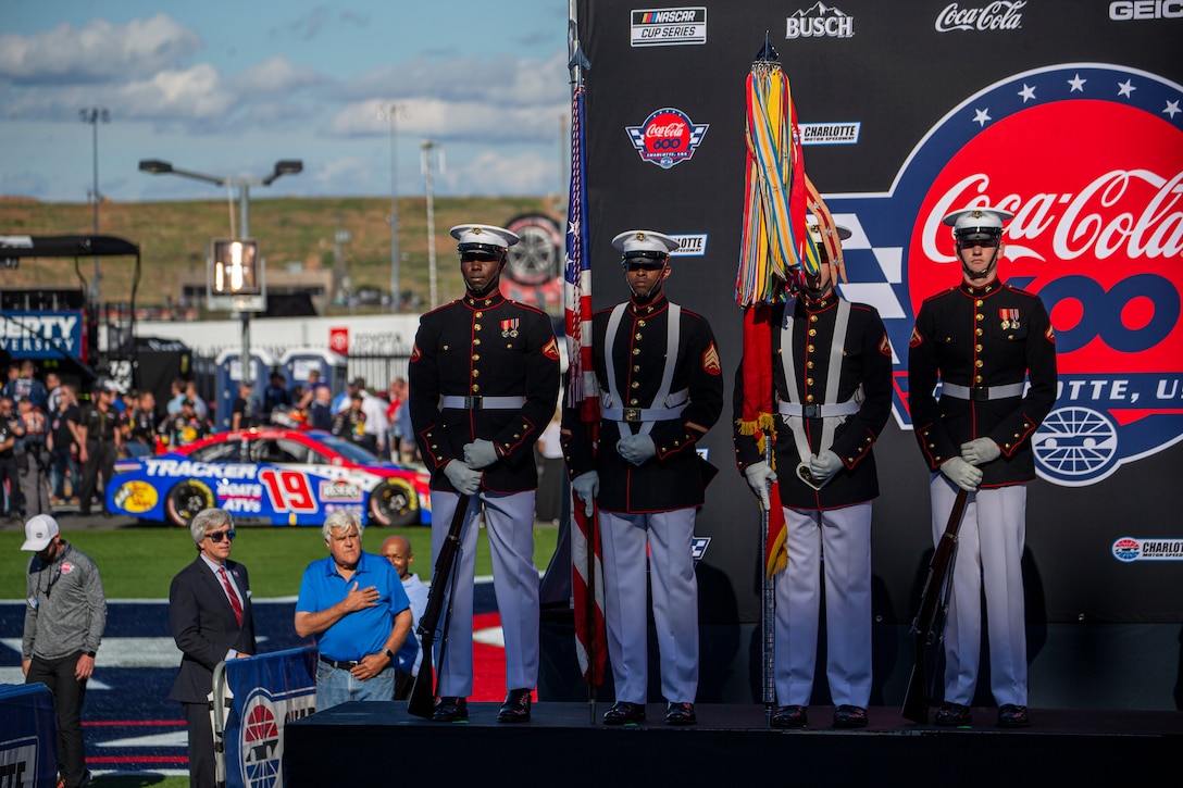Marines with the Official U.S. Marine Corps Color Guard stand at-ease prior to the Coca-Cola 600 at Charlotte Motor Speedway, Charlotte, North Carolina, May 30, 2021. The Official U.S. Marine Corps Color Guard and an Alpha Company firing party participated in the pre-race ceremony at Charlotte Motor Speedway in honor of Memorial Day. (U.S. Marine Corps photo by Lance Cpl. Tanner D. Lambert)