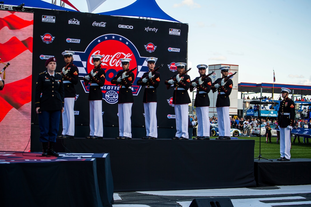 A firing party from Alpha Company, Marine Barracks Washington, fires a three round volley prior to the Coca-Cola 600 at Charlotte Motor Speedway, Charlotte, North Carolina, May 30, 2021. The Official U.S. Marine Corps Color Guard and an Alpha Company firing party participated in the pre-race ceremony at Charlotte Motor Speedway in honor of Memorial Day. (U.S. Marine Corps photo by Lance Cpl. Tanner D. Lambert)