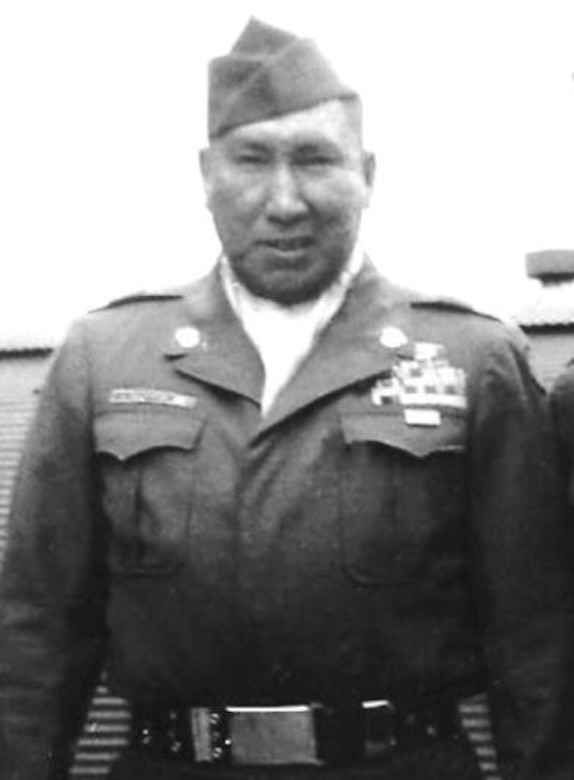 A man dressed in a military uniform poses for a photo.