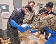 U.S. Army Medical Materiel Command-Korea employees receipt and confirm cold-chain integrity of Pfizer vaccines arriving at Camp Carroll, South Korea, May 17, 2021. The vaccines were shipped May 14, 2021, from Defense Logistics Agency Distribution Susquehanna, Pennsylvania, as part of the Defense Department mission to vaccinate overseas DOD adolescents. (Photo courtesy of USAMMC-K)
