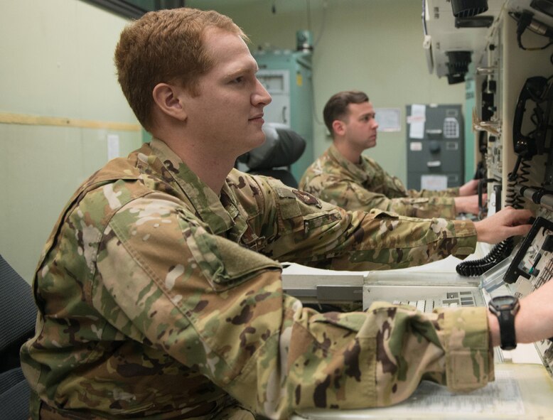 1st Lt. Joseph Bruno, 10th MS missileer, left, and Capt. Ryan Huston, 10th Missile Squadron mission lead combat crew commander, right, perform a training simulation intercontinental ballistic missile launch, inside the missile procedures training simulator May 27, 2021 at Malmstrom Air Force Base, Mont.