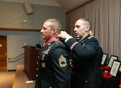 Col. Woodrow Miner, commander of the 204th Maneuver Enhancement Brigade, places the bronze de Fleury medal on Sgt. 1st Class Kevin Dimond, a member of the 118th Engineer Co. (Sapper), 1457th Engineer Battalion, in a ceremony at the Utah National Guard Headquarters May 22, 2021.